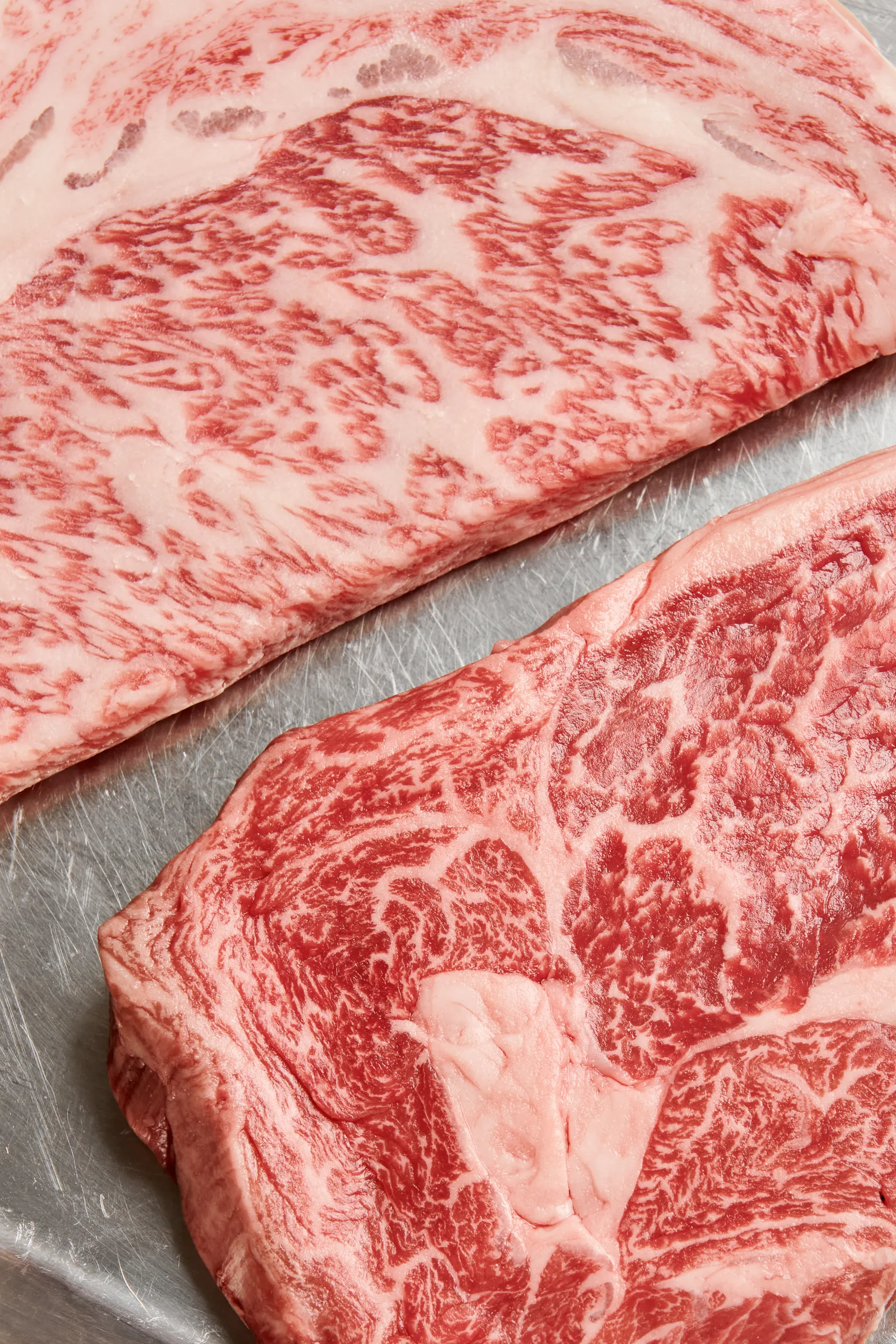 Close-up of marbled beef – dry-aged steak with rich fat marbling.